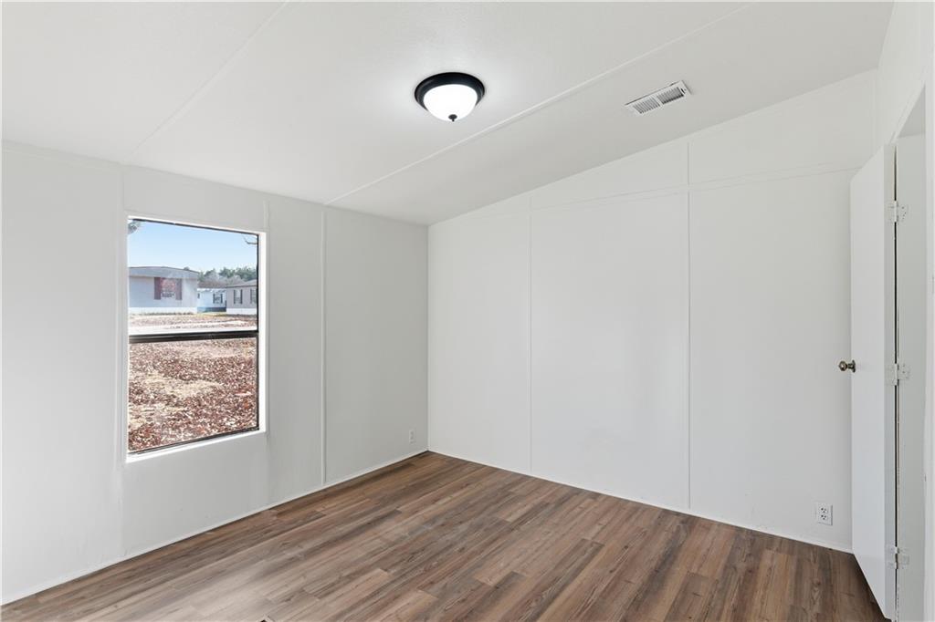 129 Rising Fawn Trail Northeast Rome, GA 30165 - Photo 19 of 28 a view of an empty room with wooden floor and a window