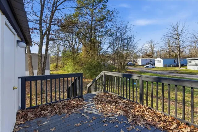 a balcony with wooden floor and fence