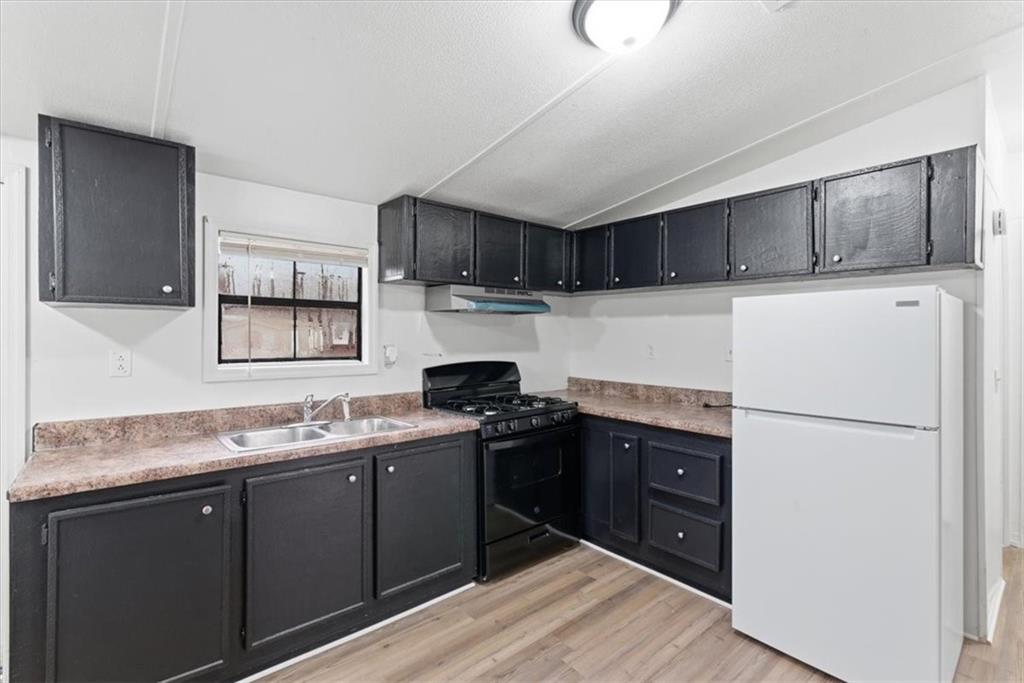 129 Rising Fawn Trail Northeast Rome, GA 30165 - Photo 4 of 28 a kitchen with a sink a stove and refrigerator