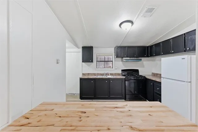 a kitchen with stainless steel appliances granite countertop a stove and a refrigerator