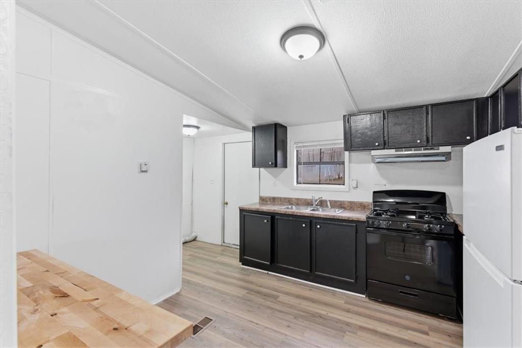 129 Rising Fawn Trail Northeast Rome, GA 30165 - Photo 8 of 28 a kitchen with stainless steel appliances granite countertop a stove and a refrigerator