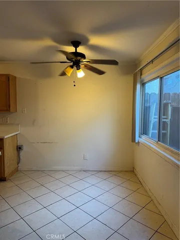a view of a room with a window and a fan