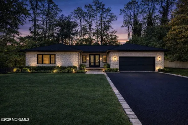a front view of a house with a garden