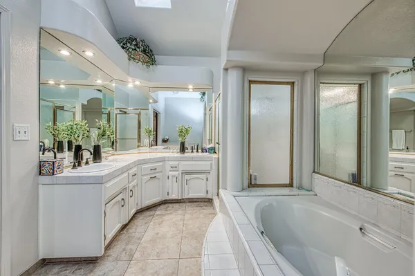 a bathroom with a granite countertop toilet sink and mirror