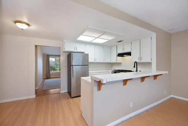 a kitchen with stainless steel appliances a sink a stove and a refrigerator