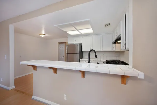a view of an empty room with a rug