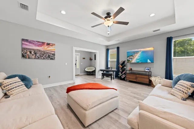 a bedroom with furniture and a large window
