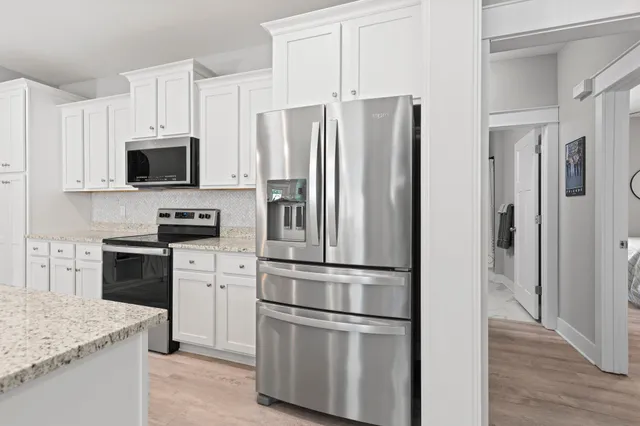 a kitchen with stainless steel appliances and refrigerator