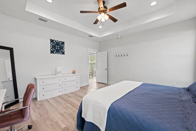 a bedroom with a bed and a dresser in it