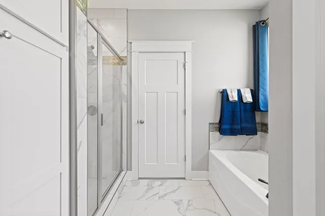 a bathroom with a bathtub and a shower
