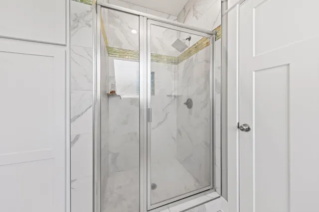 a bathroom with a glass shower door