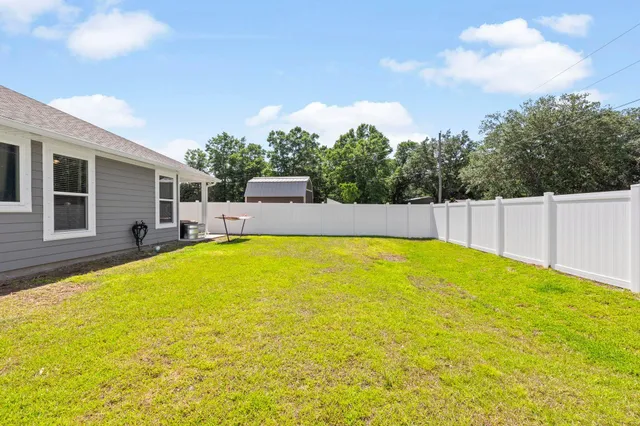 a view of swimming pool with palm trees
