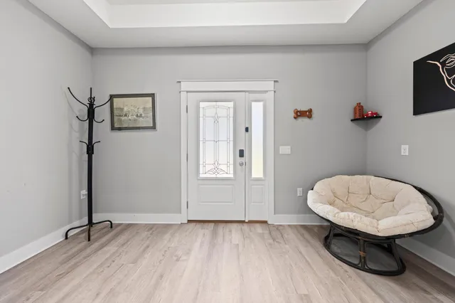 a view of a room with wooden floor and a sink