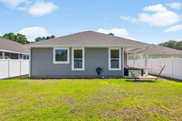 a swimming pool with outdoor seating and yard