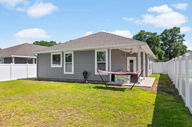 a swimming pool with outdoor seating and yard