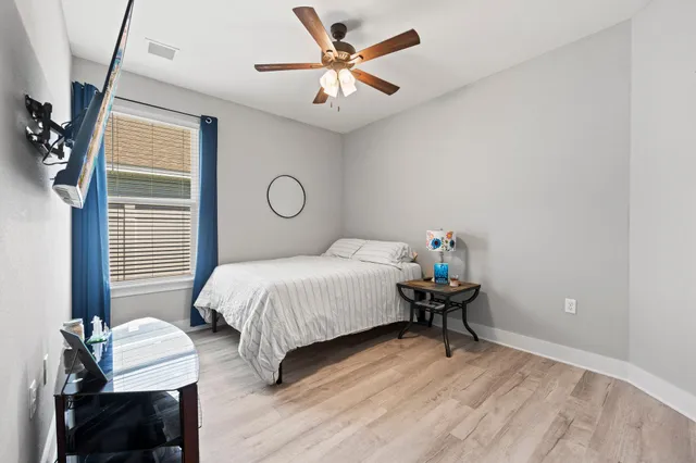 a bedroom with a bed and a chandelier