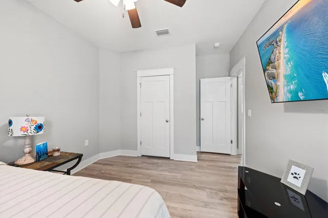 a bedroom with a bed and a view of kitchen
