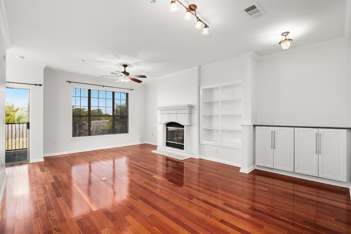 wooden floor fireplace and natural light in room