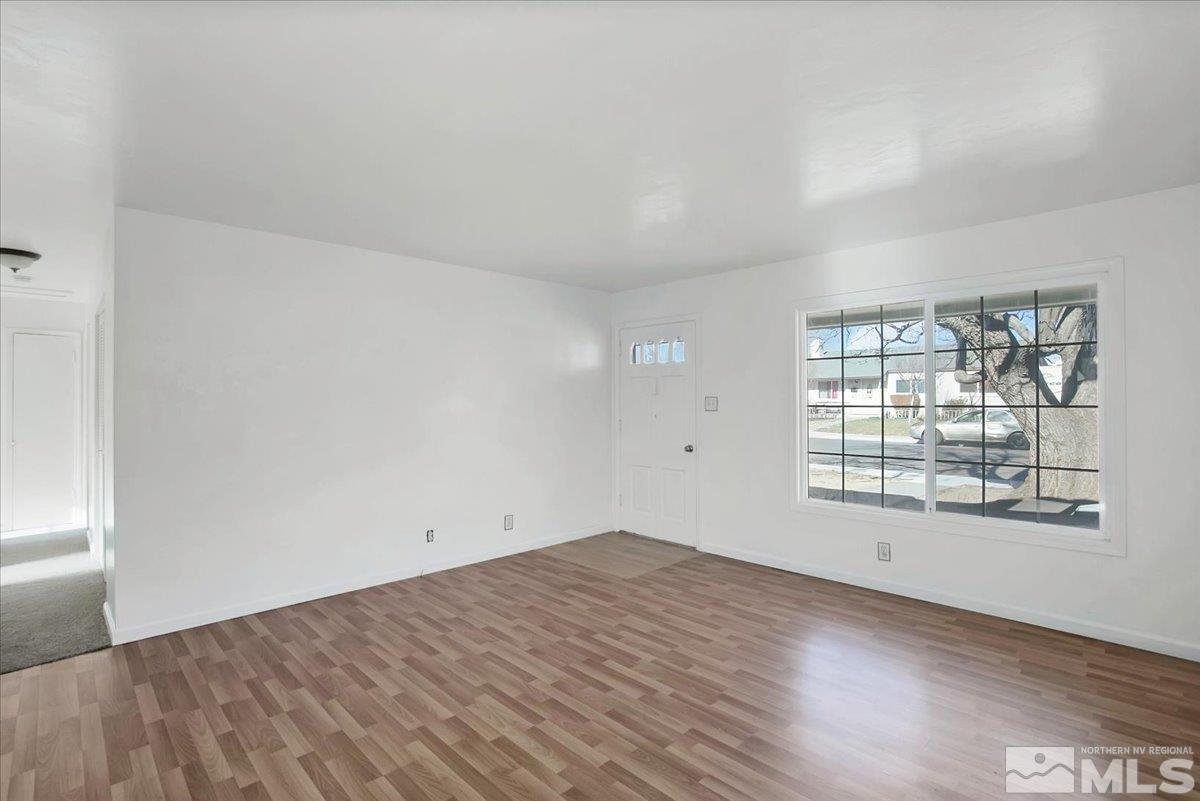 1630 Dayton Way Reno, NV 89502 - Photo 23 of 36 an empty room with wooden floor and windows
