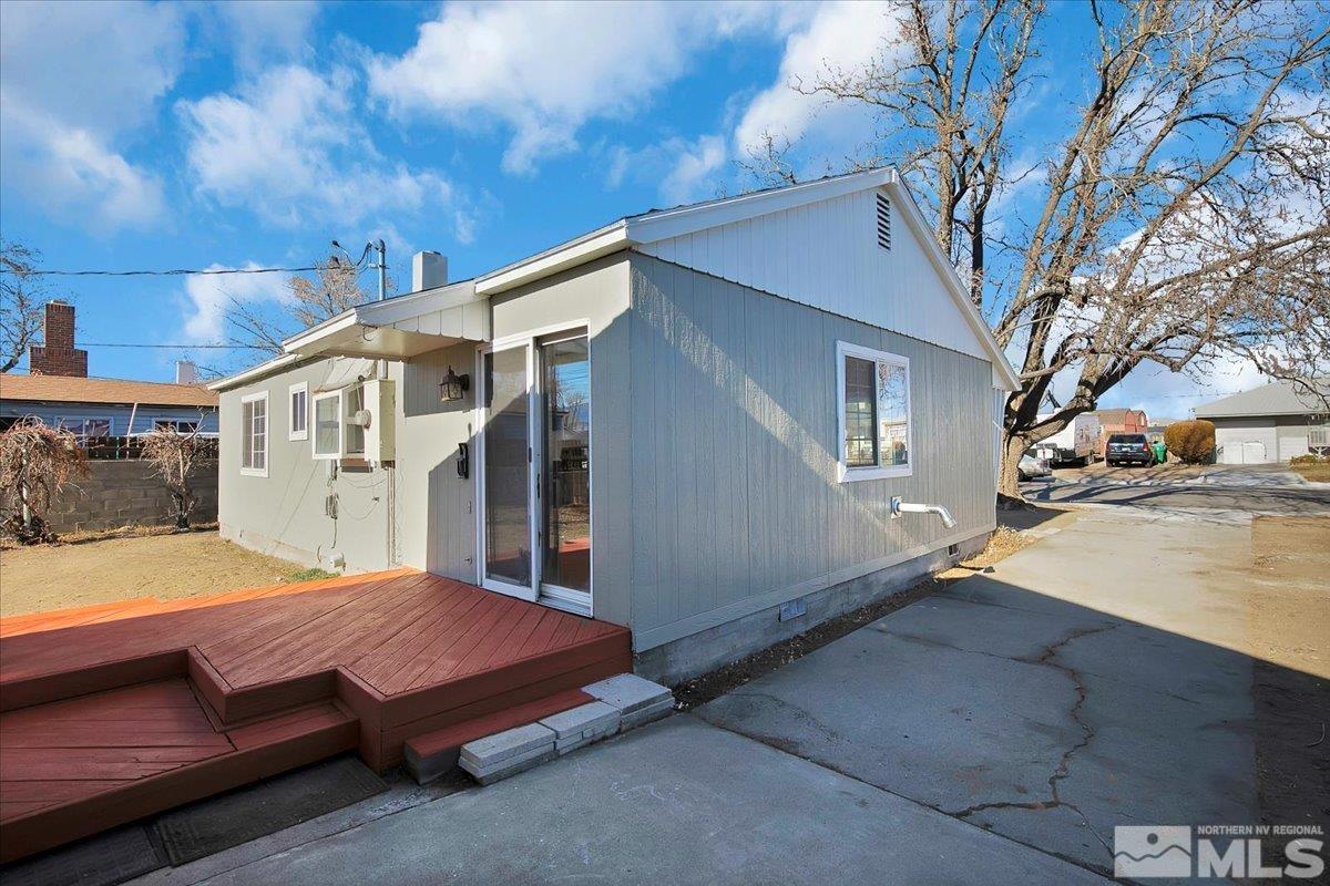 1630 Dayton Way Reno, NV 89502 - Photo 31 of 36 a backyard of a house with large trees and parked