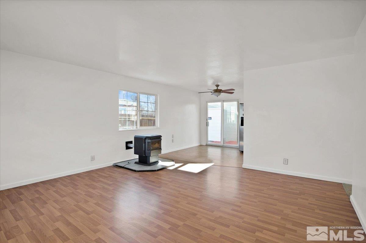 1630 Dayton Way Reno, NV 89502 - Photo 4 of 36 an empty room with wooden floor and windows