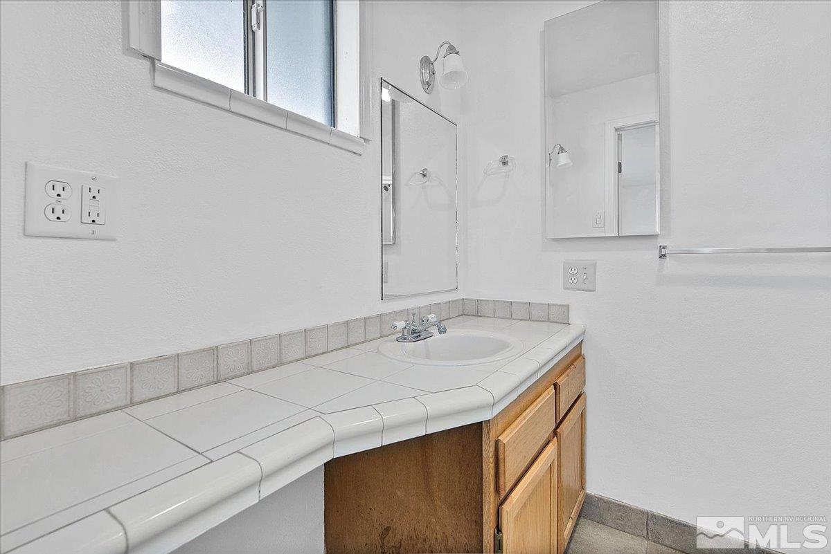 1630 Dayton Way Reno, NV 89502 - Photo 9 of 36 a bathroom with a sink and vanity