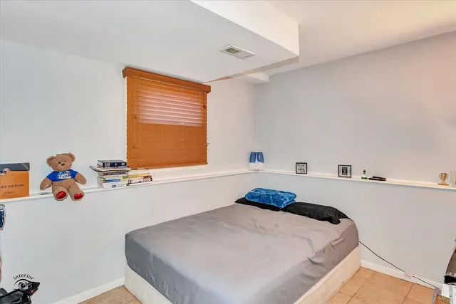 a bedroom with a bed and window