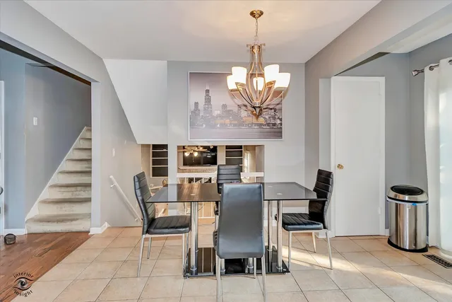 a view of a dining room with furniture wooden floor and chandelier