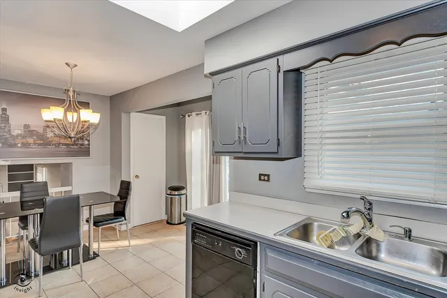 a kitchen with a sink cabinets and window