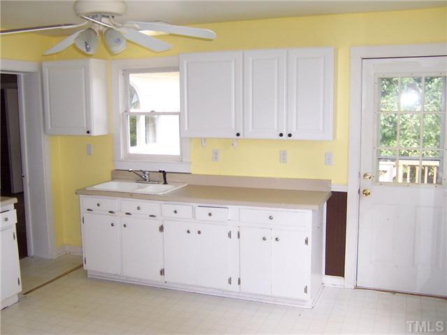 2621 Layden Street Raleigh, NC 27603 - Photo 7 of 9 a view of cabinets a window wooden floor and a sink