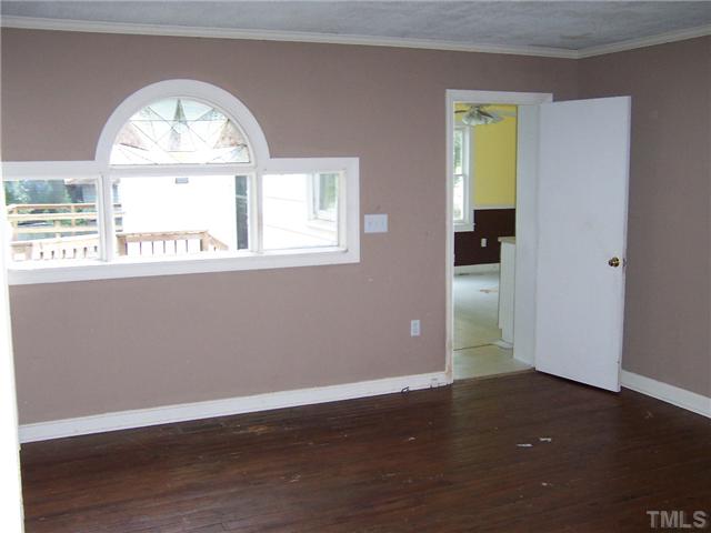 2621 Layden Street Raleigh, NC 27603 - Photo 8 of 9 an empty room with wooden floor and a window