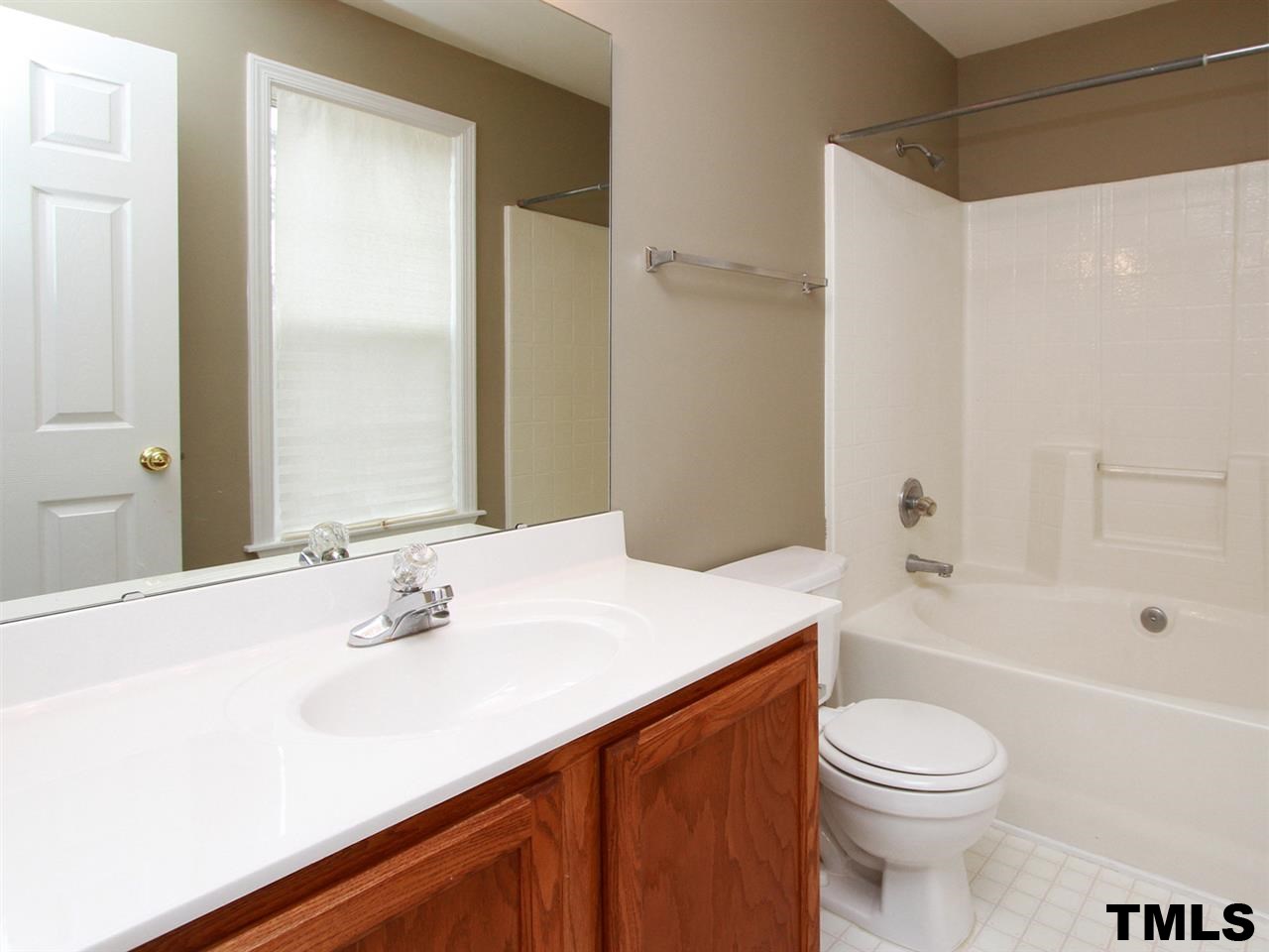 4409 Archibald Way Raleigh, NC 27616 - Photo 12 of 23 a bathroom with a sink a toilet and shower