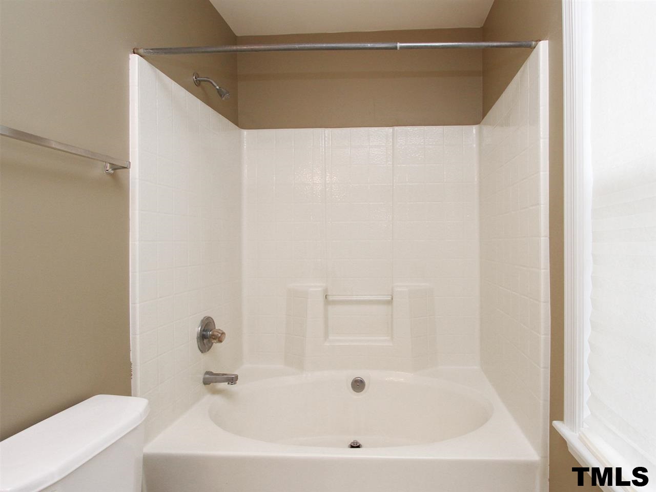4409 Archibald Way Raleigh, NC 27616 - Photo 13 of 23 a bathroom with a bathtub and a toilet