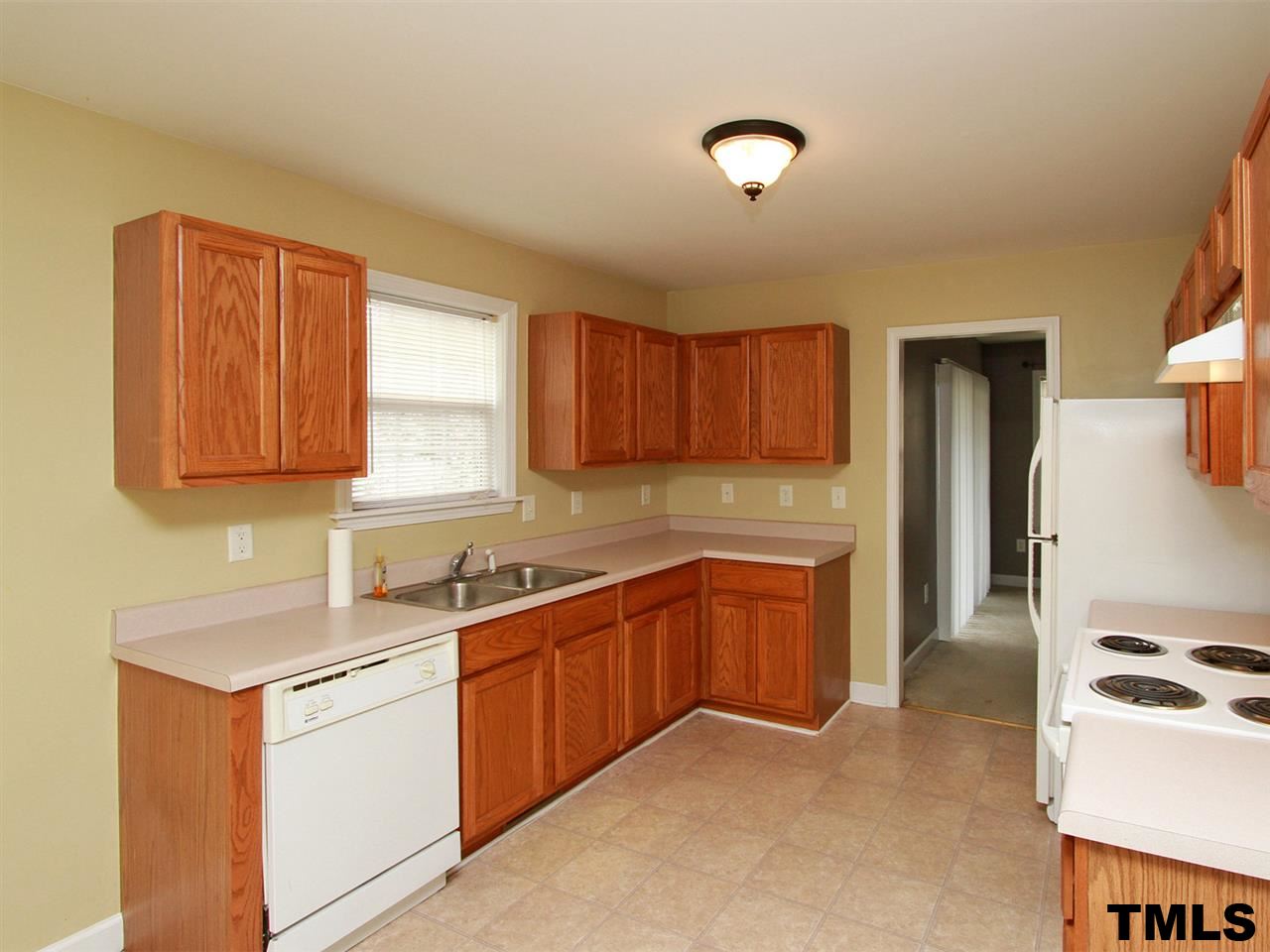 4409 Archibald Way Raleigh, NC 27616 - Photo 7 of 23 a kitchen with stainless steel appliances granite countertop a sink stove and refrigerator