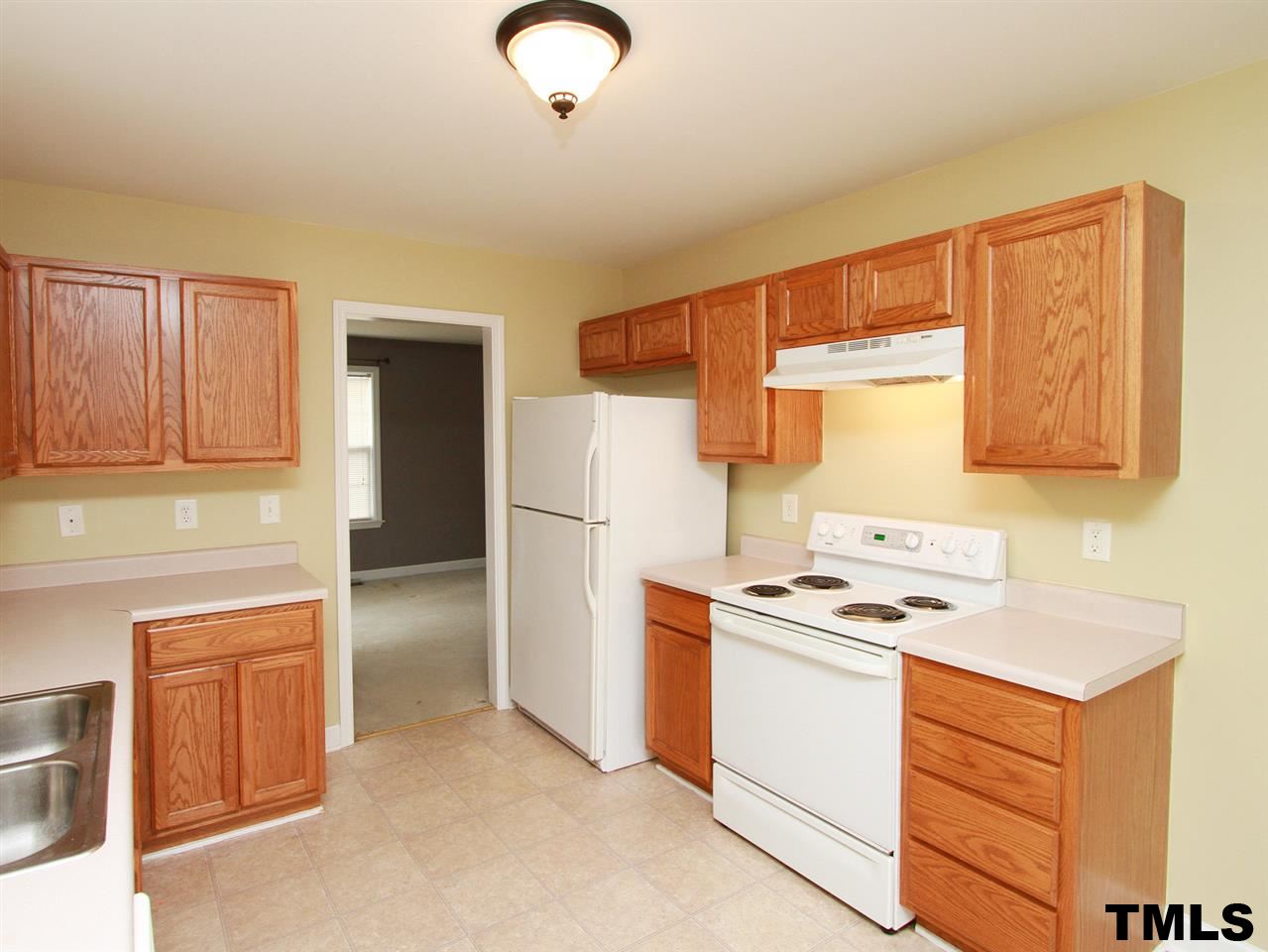 4409 Archibald Way Raleigh, NC 27616 - Photo 8 of 23 a kitchen with a stove cabinets and refrigerator