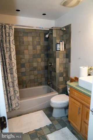 a bathroom with a toilet a sink and bathtub