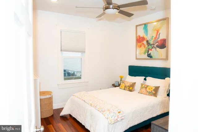 a bedroom with a bed and a painting on the wall