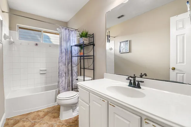 a bedroom with bed and a chandelier