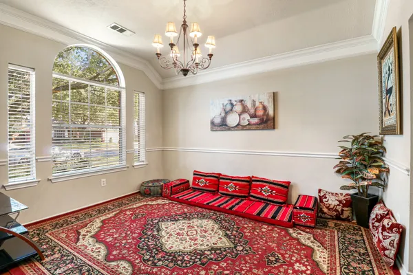 a view of a bedroom with furniture and a chandelier