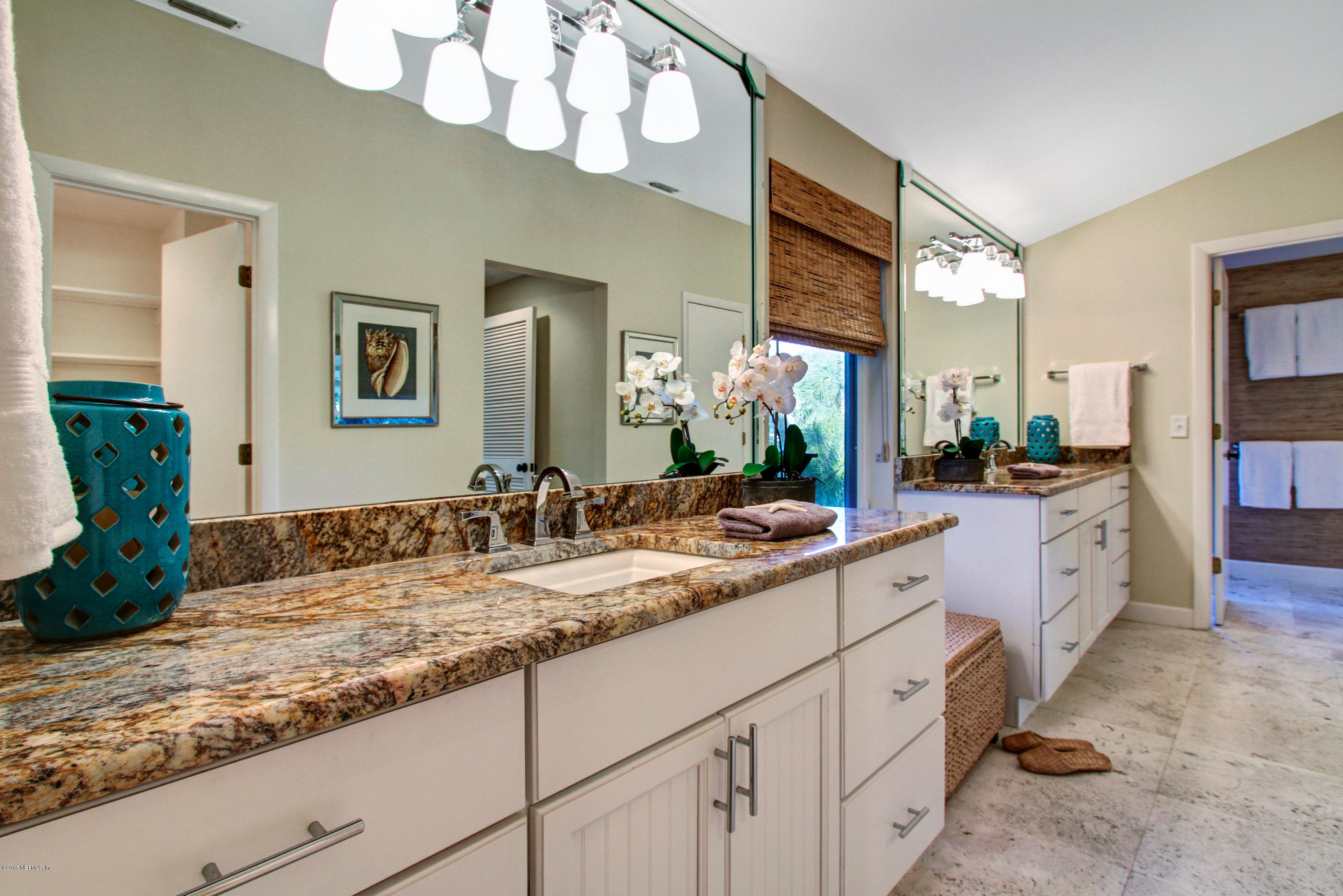 71 19th Street Atlantic Beach, FL 32233 - Photo 12 of 30 a bathroom with a sink and a mirror
