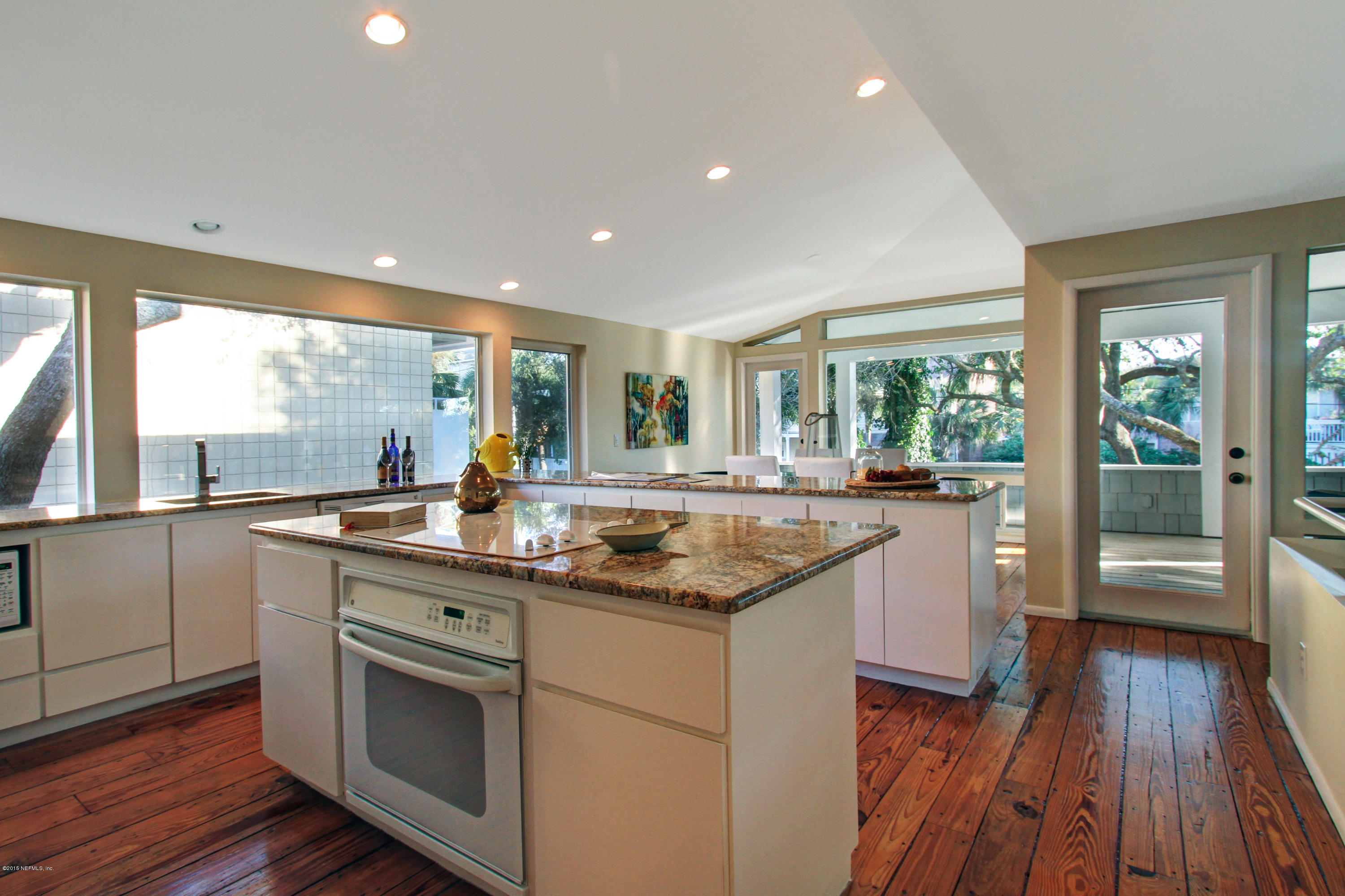 71 19th Street Atlantic Beach, FL 32233 - Photo 16 of 30 a kitchen with granite countertop a sink and wooden floor