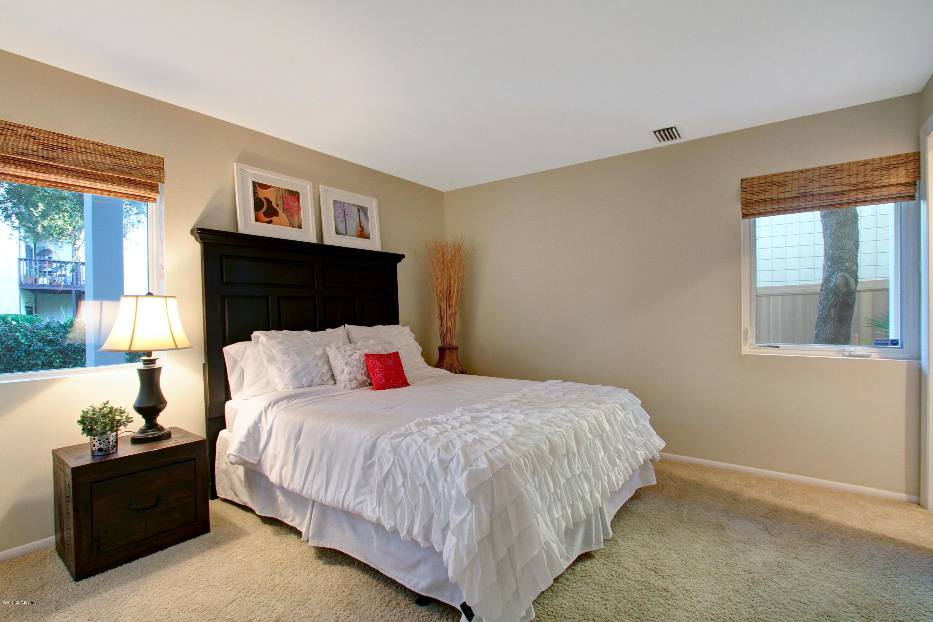 71 19th Street Atlantic Beach, FL 32233 - Photo 24 of 30 a bedroom with a bed and window