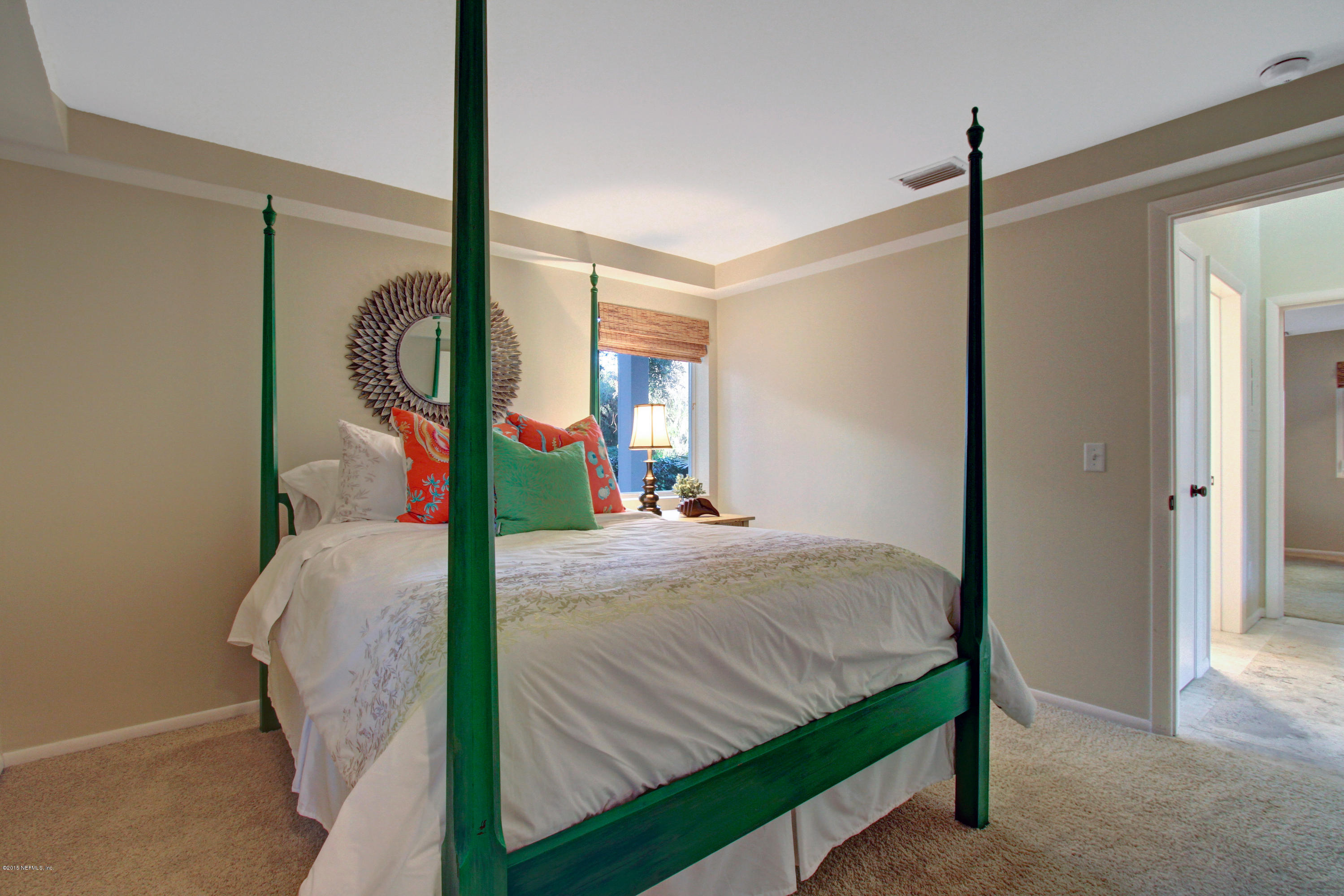 71 19th Street Atlantic Beach, FL 32233 - Photo 26 of 30 a bed room with a bed window and a mirror