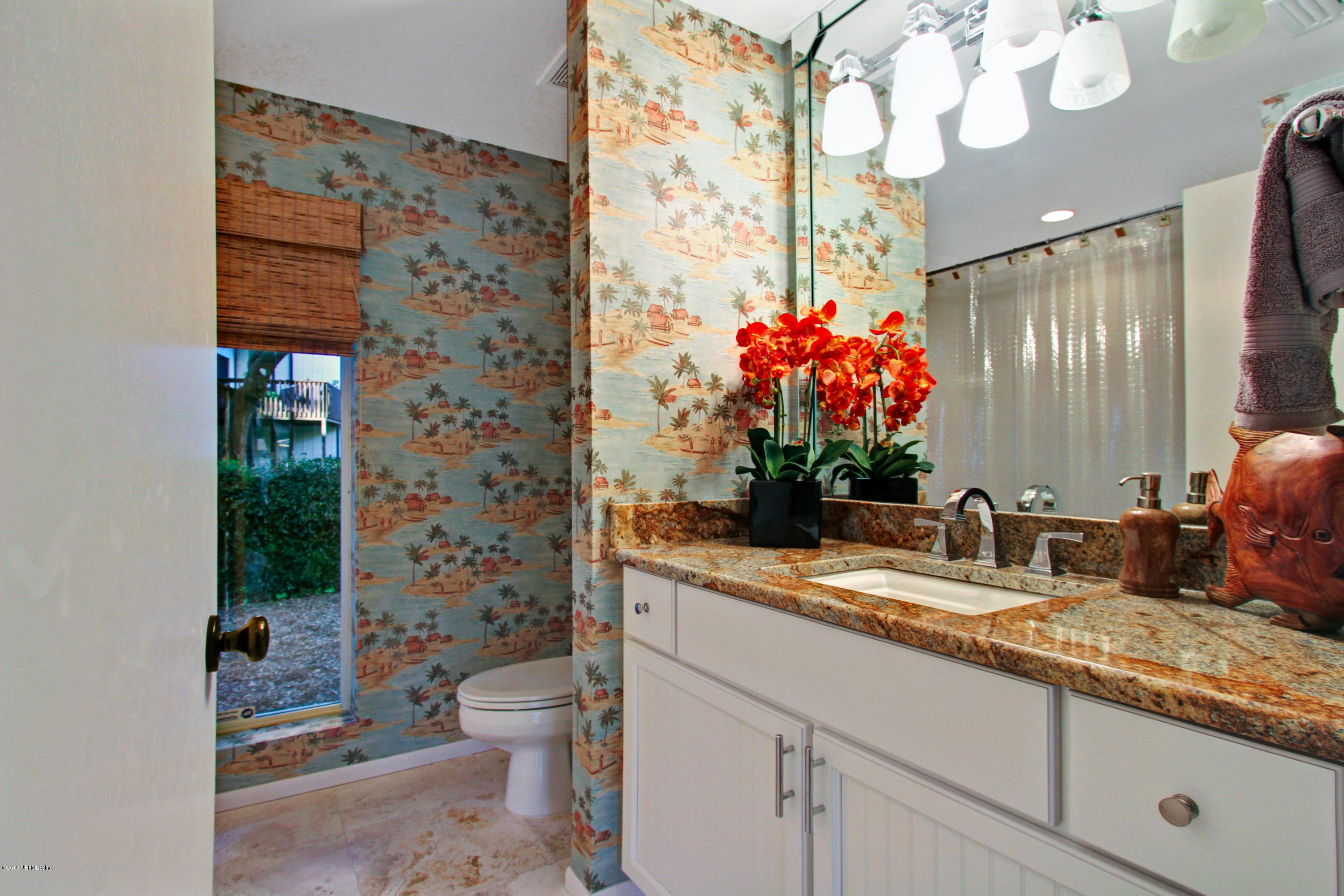 71 19th Street Atlantic Beach, FL 32233 - Photo 27 of 30 a bathroom with a granite countertop sink a toilet and a mirror