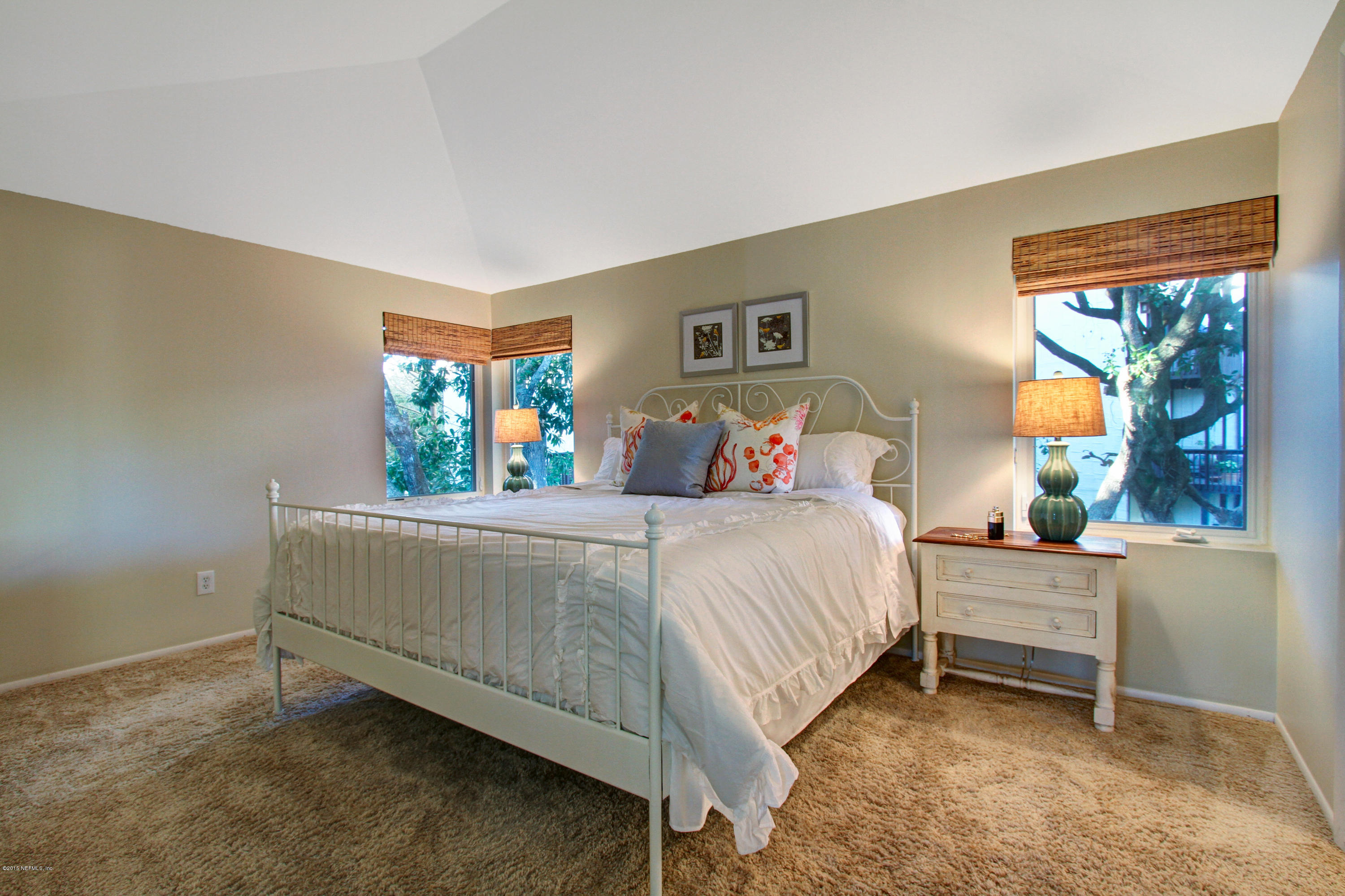 71 19th Street Atlantic Beach, FL 32233 - Photo 10 of 30 a bedroom with a bed and a window