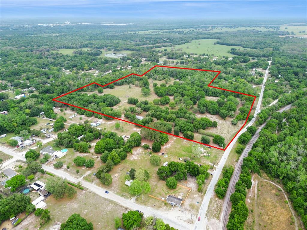 12500 Hamlin Road Spring Hill, FL 34610 - Photo 3 of 82 an aerial view of green landscape with trees houses and mountain view
