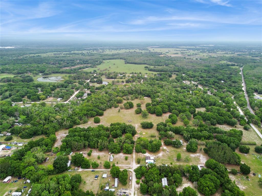 12500 Hamlin Road Spring Hill, FL 34610 - Photo 66 of 82 an aerial view of residential houses with outdoor space and trees