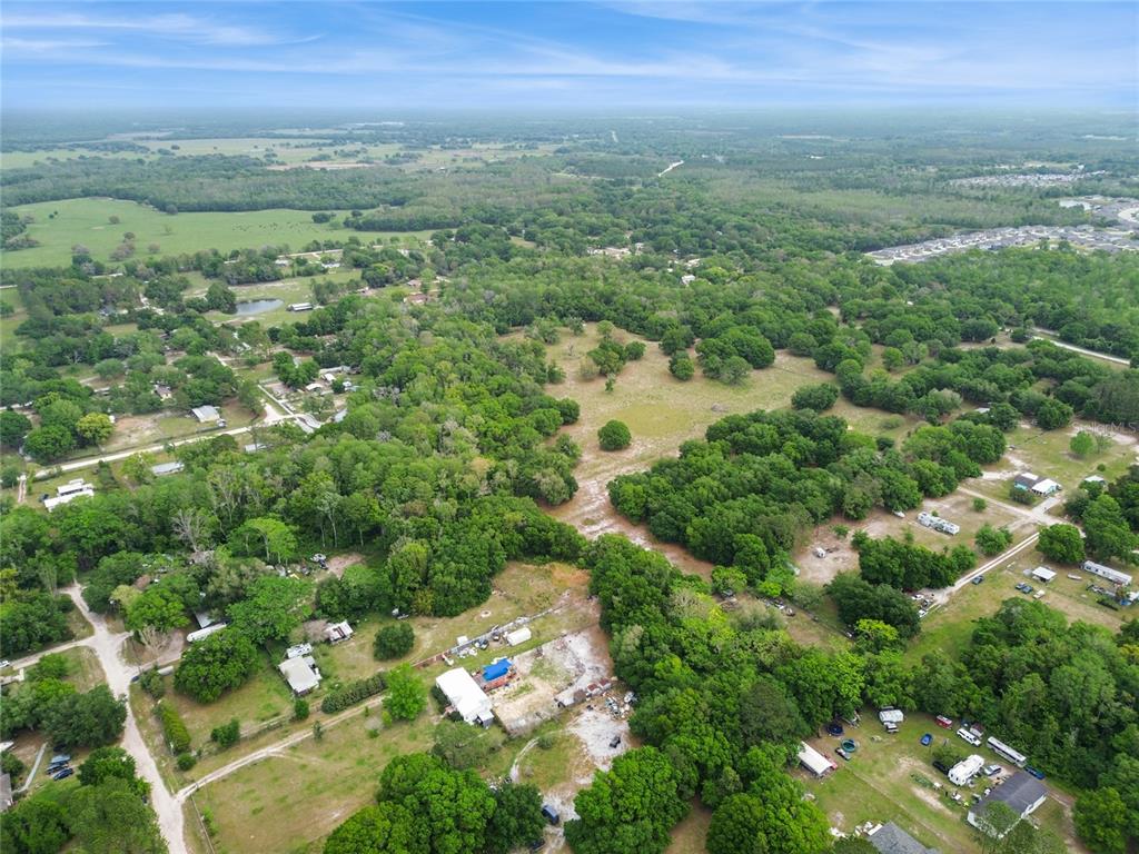 12500 Hamlin Road Spring Hill, FL 34610 - Photo 78 of 82 an aerial view of residential houses with outdoor space and trees
