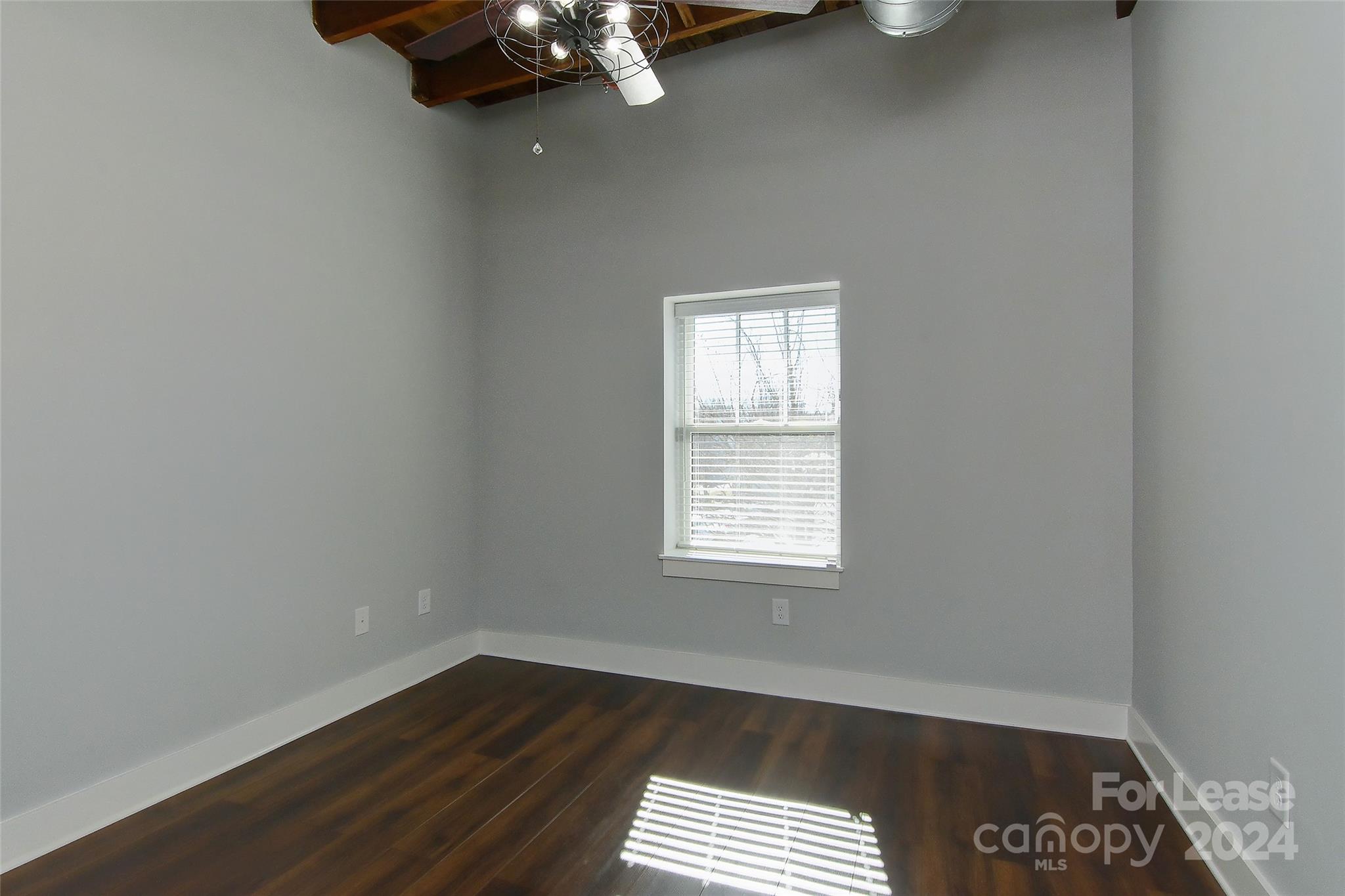 115 South Main Street, Unit 202 Monroe, NC 28112 - Photo 12 of 25 an empty room with a workspace