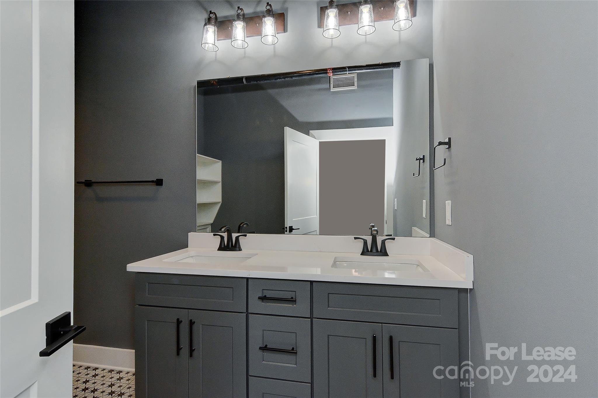 115 South Main Street, Unit 202 Monroe, NC 28112 - Photo 8 of 25 a bathroom with a sink and a mirror